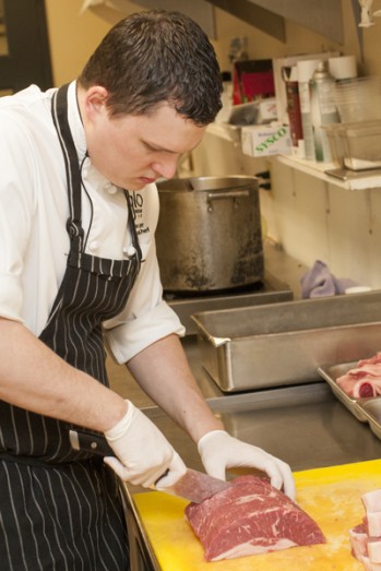 Chef Ryan slices a short loin into NY strip steaks.